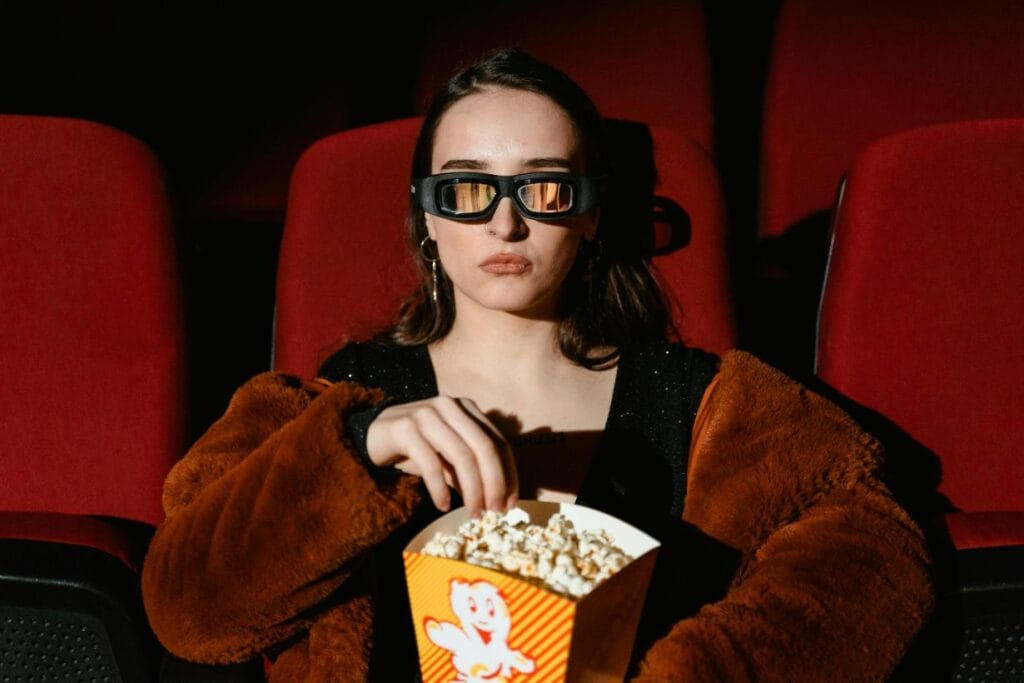 woman eating popcorn in cinema